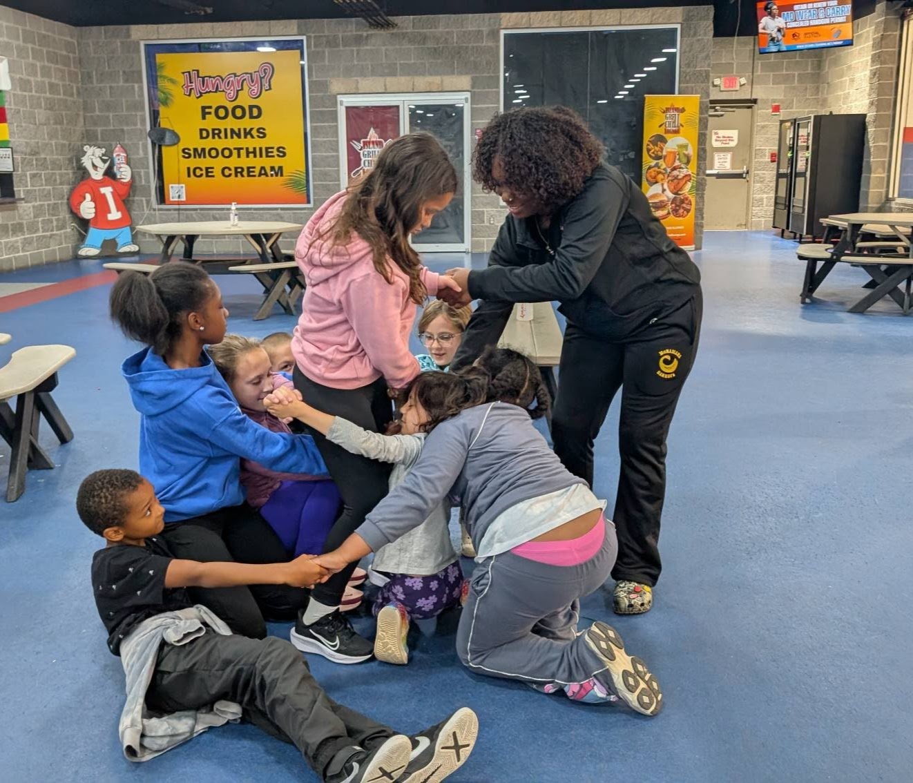 123_1 Kids on Ice holding onto one another